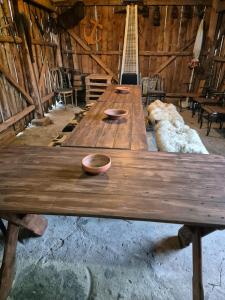 a dog laying next to a long wooden table at Siedlisko U Ani in Skrzynki