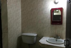 a bathroom with a toilet and a sink at Shanti Guest Guest House Varanasi by GRG in Varanasi