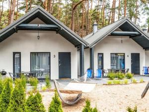 una casa con una hamaca delante en Holiday cottages close to the beach, Jaros awiec en Jarosławiec