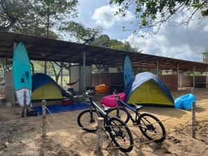 a bike parked in front of three tents at Ocean Cottage 3, Radiant Teluk Sari in Kampung Mawar