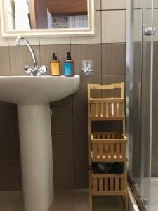 a bathroom with a sink and a mirror at The Nest Filoxenia in Kato Trikala Korinthias