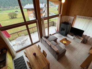 a living room with a couch and a table at Chalet Breithorn- Perfect for Holiday with Amazing View! in Obergesteln