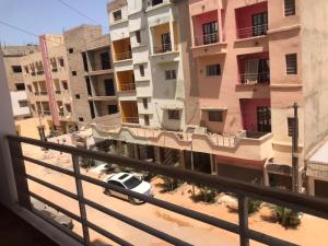 a view from a balcony of a street with buildings at Cozy Appartement Dakar in Dakar