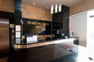 a reception desk in a building with a sign on the wall at Fragrance Hotel - Kovan in Singapore