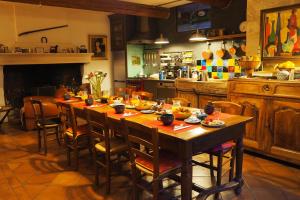 a kitchen with a wooden table with food on it at Chambres d'Hôtes Le relais des marmottes in Lagnes