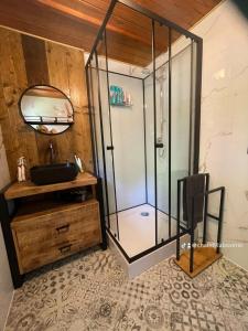 a shower with a glass door in a bathroom at Chalet 9 La Boverie in Rendeux