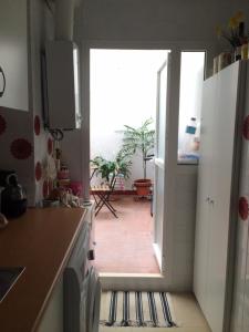 a kitchen with a door leading to a patio at URBION HOME in Seville