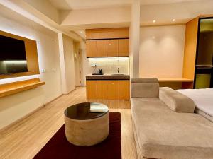 a living room with a couch and a table at ARMERIA STAY DLF MYPAD-512 in Lucknow