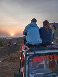 a group of people sitting on the roof of a vehicle at jeep tour bali in Kintamani
