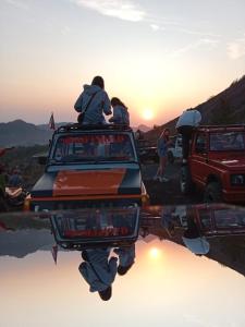 a group of people sitting on the back of a truck at jeep tour bali in Kintamani