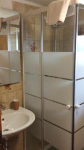 a bathroom with a sink and a refrigerator at B&B SòT AL PIZ in Sagron Mis +28 photos