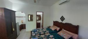 a bedroom with a bed and a mirror at Catra Homestay beachroom 10 B in Karangasem