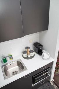 a kitchen counter with a sink and a toaster at Port View Suite, Kavala in Kavala +16 photos