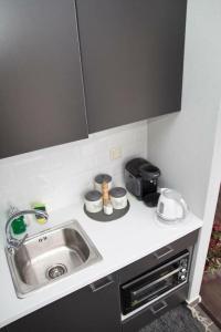 a kitchen counter with a sink and a toaster at Port View Suites 2 in Kavála