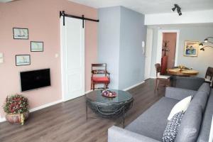 a living room with a couch and a table at Port View Suite, Kavala in Kavala