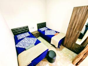 a room with two beds and two chairs at GUEST HOUSE NONA in Chakvi