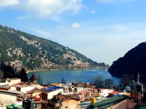 a view of a town with a lake and mountains at Hotel Radha Continental Nainital Near Mall Road - Hygiene & Spacious Room - Prime Location - Best Selling in Nainital