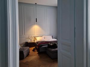 a room with a bed and a chair and a closet at Victory Apartment in Timişoara