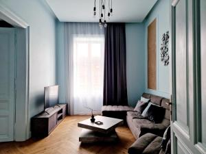 a living room with a couch and a table at Victory Apartment in Timişoara +30 photos
