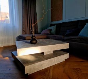 a concrete coffee table in a living room at Victory Apartment in Timişoara