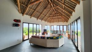 a living room with a couch and a table at Luxury Beach Villa - Mozambique in Inhambane
