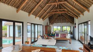 a living room with a couch and a table at Luxury Beach Villa - Mozambique in Inhambane
