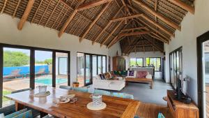 a living room with a table and a couch at Luxury Beach Villa - Mozambique in Inhambane