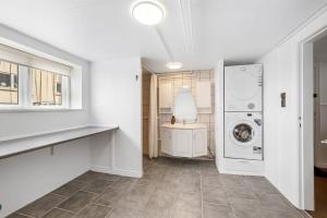 a white laundry room with a washer and dryer at Nyd den skønne natur ved hav og fjord in Thyborøn +44 photos