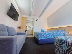 a hotel room with a bed and a couch at Seymour Motel in Seymour