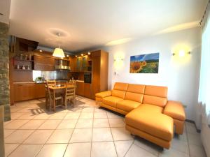 a living room with a couch and a kitchen at CASA VACANZA Residence Lago di Endine in Monasterolo del Castello +60 photos