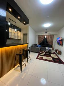 a kitchen and living room with a bar and a couch at Homestay in Cheras