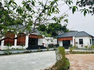 a house with a courtyard in front of it at Diep's House in Hanoi