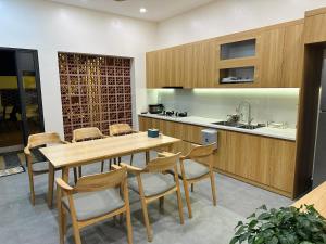 a kitchen with a wooden table and chairs at Diep's House in Hanoi