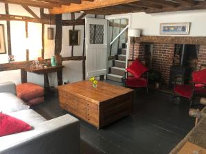 a living room with a couch and a table at Hastings Old Town. Cottage - by the sea in Hastings