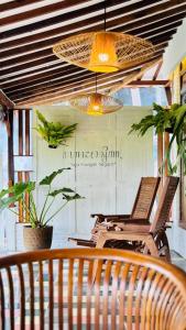 a room with two chairs and a table and a lamp at Villa Sare - House with panorama rice field view in Yogyakarta