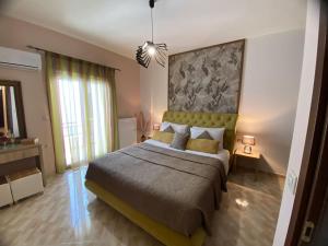 a bedroom with a large bed with a large painting on the wall at Spacious & Modern New Apartment in Heraklio Town
