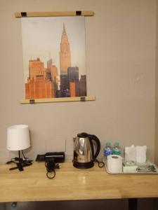 a desk with a tea kettle and a lamp on it at GO INN Silom - BTS Surasak station in Yan Nawa