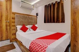 a bedroom with a bed with red pillows at OYO Hotel Kishan in Mumbai