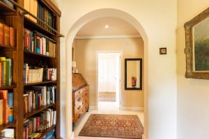 an archway leading to a hallway with bookshelves at Cozy Mallorca! in Palma de Mallorca