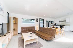 a living room with a couch and a table at Eden villas in Nathon Bay