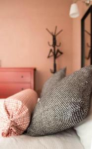 a room with pillows on a bed with a cross on the wall at Port View Suite, Kavala in Kavala