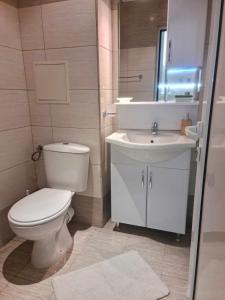 a bathroom with a toilet and a sink at Aglaya 2 - Pomorie Bay in Pomorie