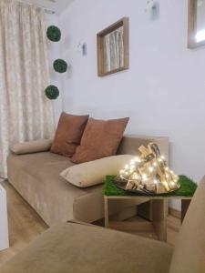 a living room with a couch and a table with lights at Aglaya 2 - Pomorie Bay in Pomorie