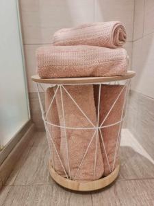 a pile of towels on a towel rack in a bathroom at Aglaya 2 - Pomorie Bay in Pomorie