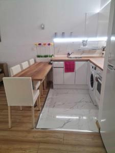 a kitchen with a table and a washing machine at Aglaya 2 - Pomorie Bay in Pomorie