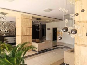 a living room with a couch and a chair at Aglaya 2 - Pomorie Bay in Pomorie