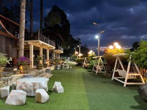 a garden with rocks on the grass at night at Paradise on the Tree in Cat Tien