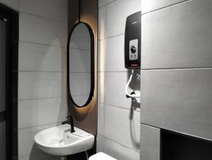 a bathroom with a sink and a mirror at Urban Inn, Salak Tinggi in Sepang