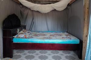 a bed in a room with a canopy at Bà Ngoại Homestay in Cà Mau