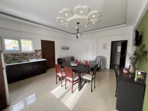 a kitchen and dining room with a table and chairs at Anatoli deluxe house in Amoudi